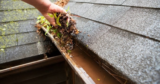 Hand cleaning copper rain gutter